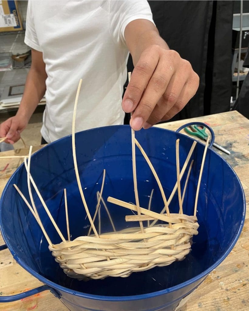 student making a basket weaving